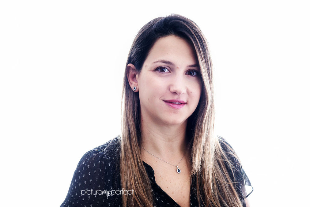 Professional headshot of a woman with long brown hair smiling, Fontainebleau,The Greens