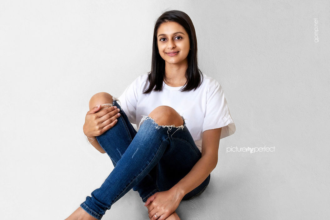 Smiling young woman in white t-shirt and jeans, Olympia Heights