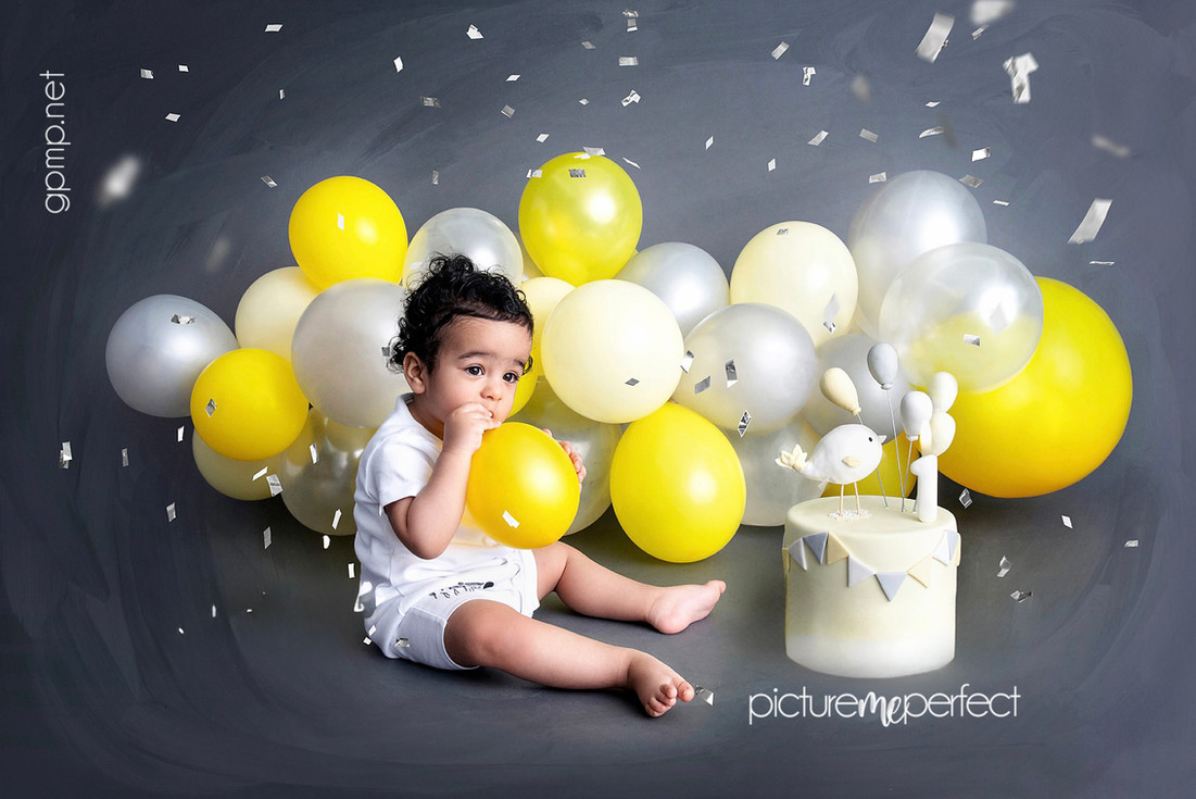 Curious baby at 1st birthday cake smash with yellow balloons, At his home  photo shoot in Miami , Laguna Springs