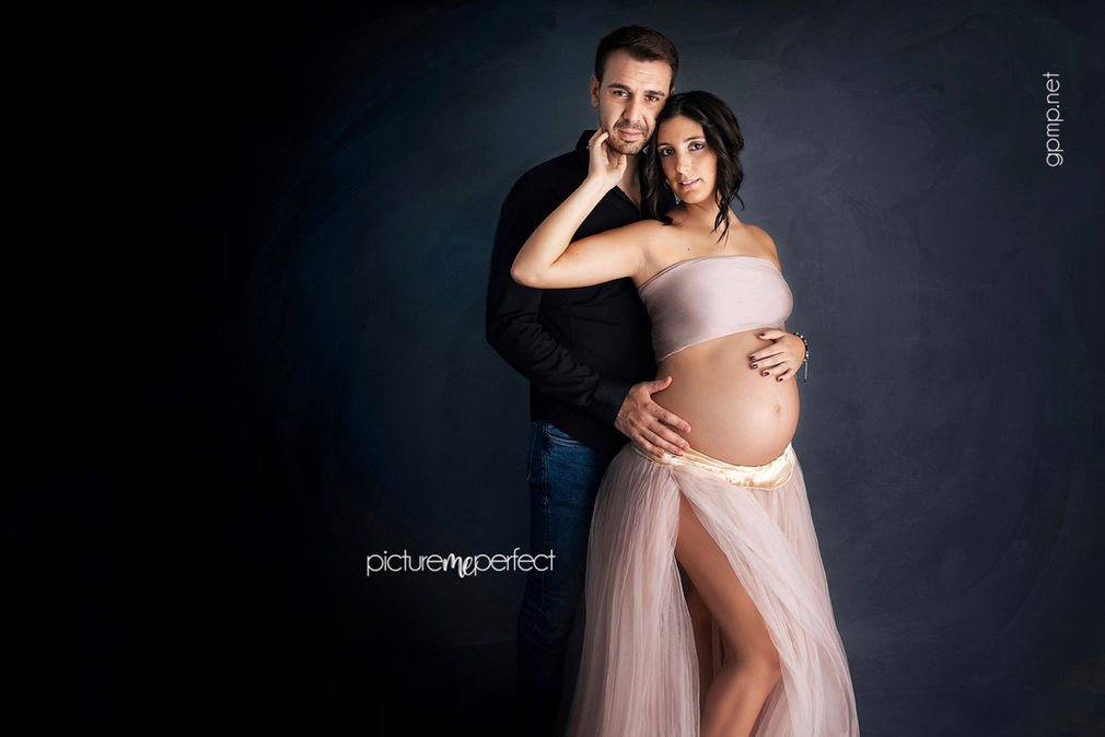 Man embracing pregnant woman, hands on her baby bump , beige tutu dress, photo shoot at Windmill Ranch Estates