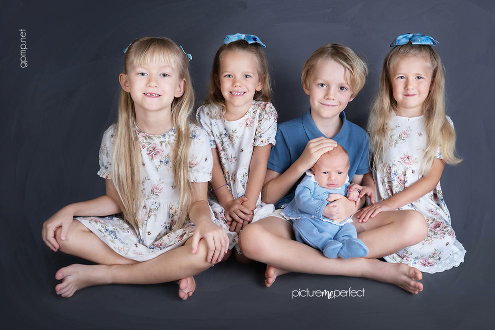 Four smiling children holding sibling a newborn baby boy , Miami Silver Lakes photo shoot