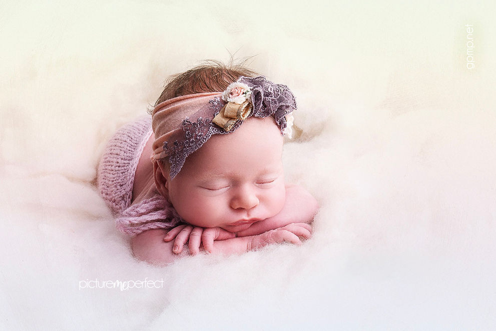 Newborn baby girl sleeping on white fluffy wool with lace pink purple headband. Miami The Ridges photo shoot