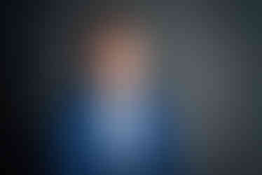 Professional portrait of a smiling man in a blue suit.At his office photo shoot in Miami , Laguna Springs