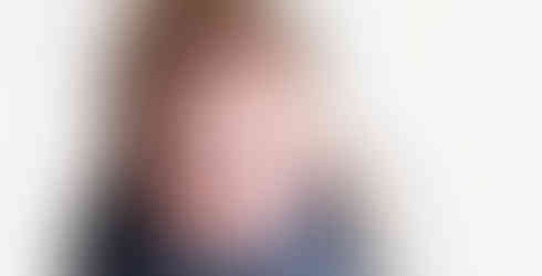 Awake, curious newborn baby swaddled in a blue knit wrap. At his home in Miami , The Ridges