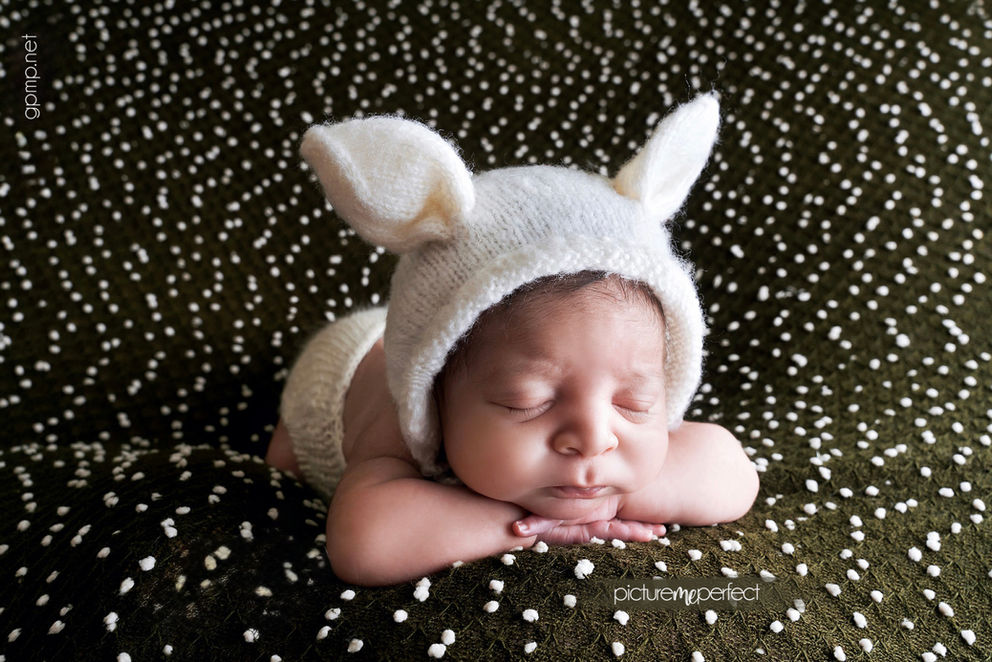 Newborn baby boy sleeping in bunny knitted white bonnet. Miami Silver Shores photo session
