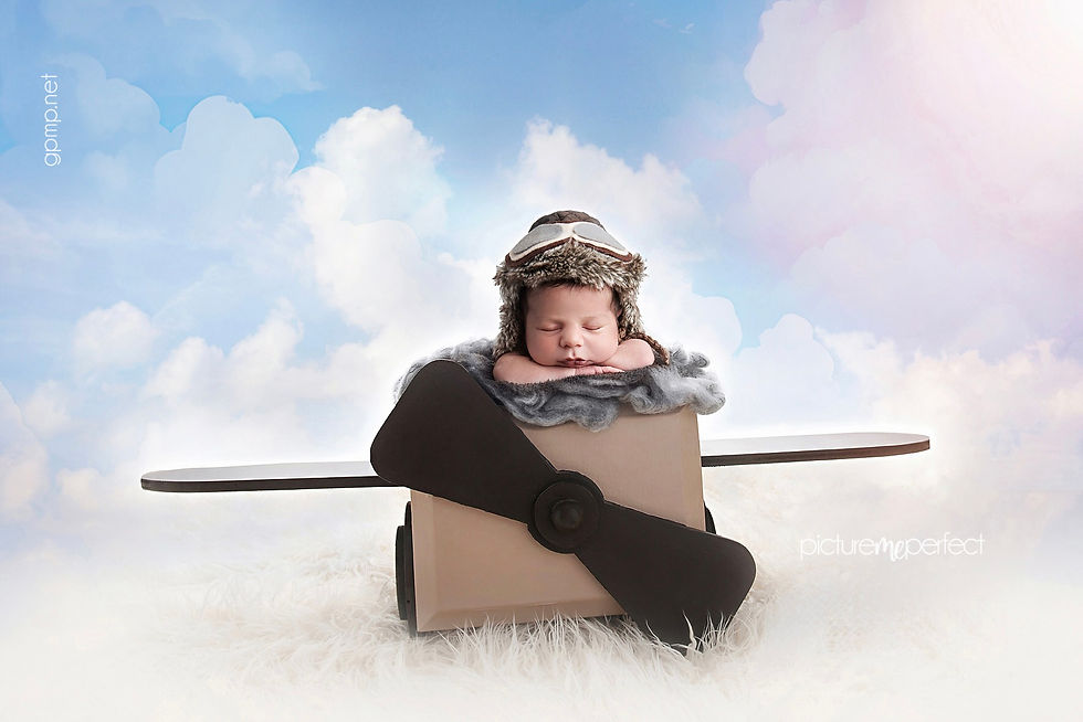 Newborn baby posed in a handmade airplane prop during an aviation-themed newborn photography session in Miami.