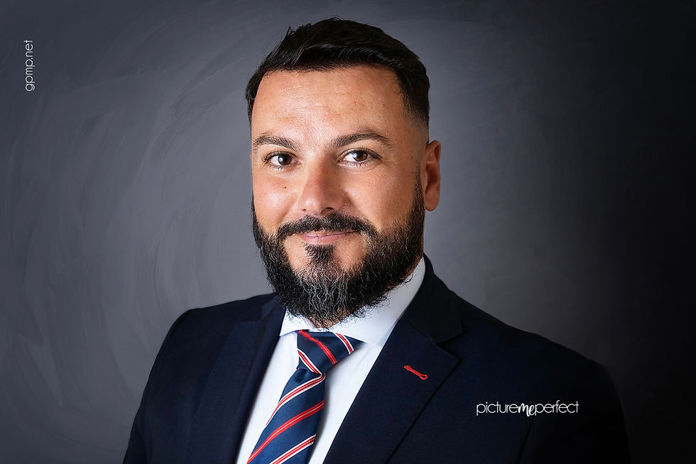 Smiling bearded man in a suit and striped tie. At his office photo shoot in Miami , Laguna Springs