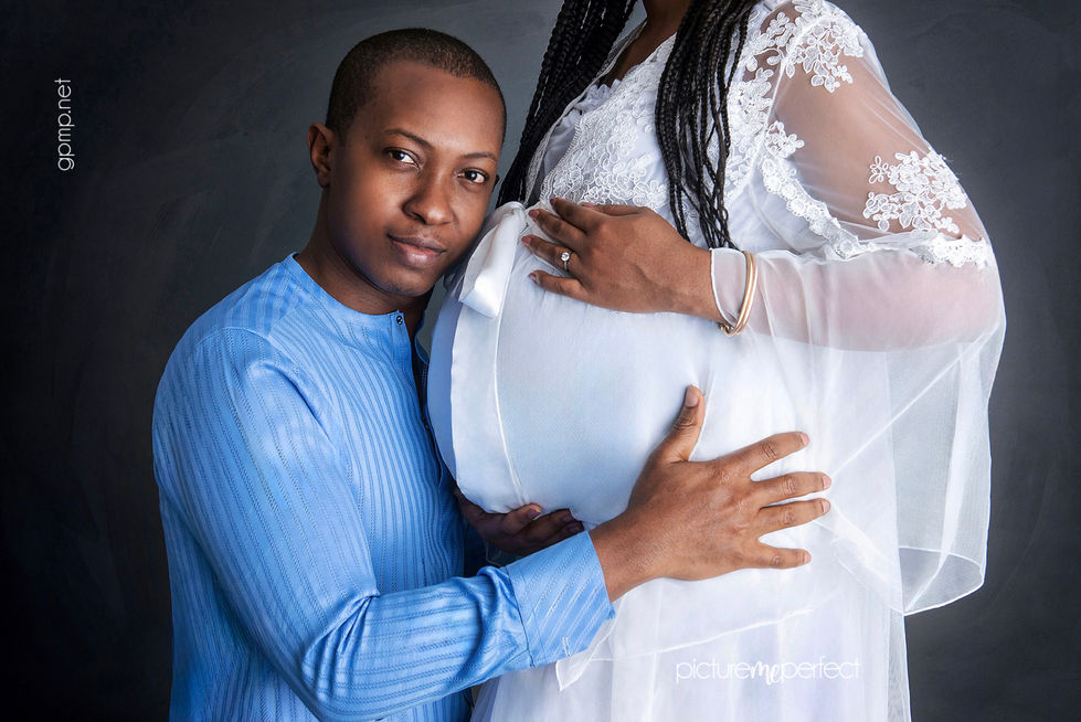 Man holding pregnant woman's belly. Miami Lakes,Cypress Village. Espresso-toned skin