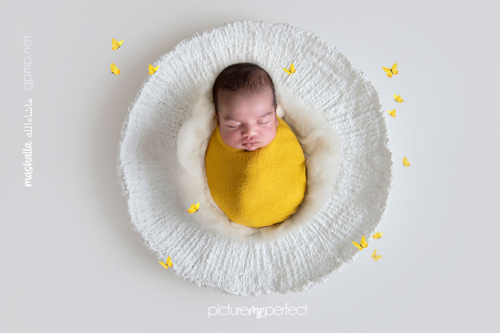 Newborn baby wrapped in yellow in a white textured bowl. photo session at his home in Monarch Lakes , miami