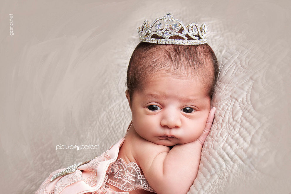 15 days old Newborn baby girl with a sparkling crown, eyes wide open . Miami Silver Shores photo session