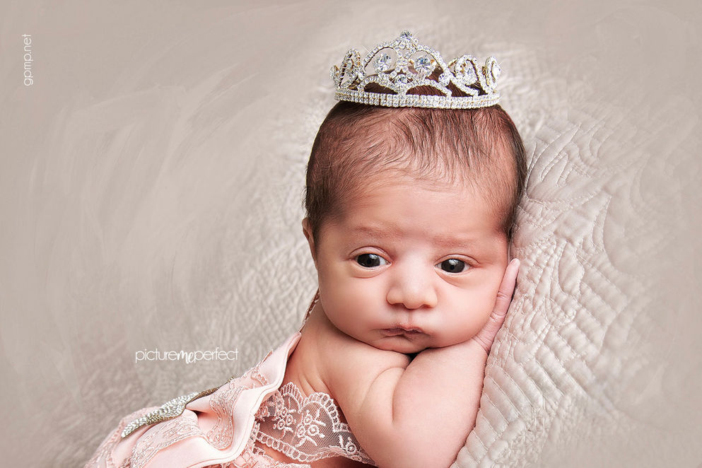 15 days old Newborn baby girl with a sparkling crown, eyes wide open . Miami Silver Shores photo session