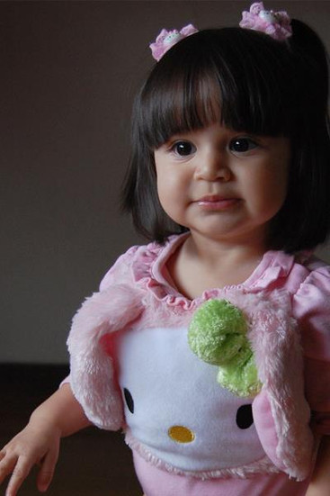 Smiling young girl with dark hair wearing a pink outfit. In-Home photo shoot at Miami , Emerald Estates