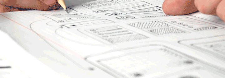 Short video showing a close up of a hand drawing website designs on paper