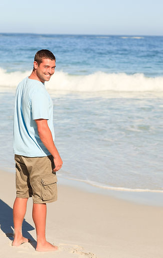 Happy, healthy man next to ocean