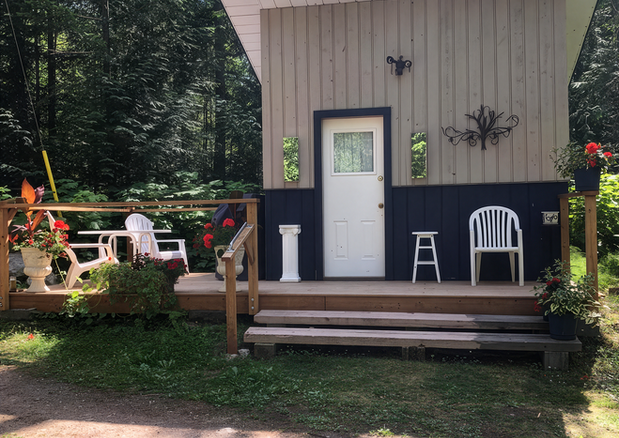 Cabin One entrance with outdoor seating at Hummingbird Cabins 'n' Breakfast between Fauquier and Nakusp, British Columbia