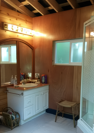 Shared bathroom interior with vanity and sink at Hummingbird Cabins 'n' Breakfast on Lower Arrow Lake
