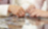 two sets of hands working on a puzzle