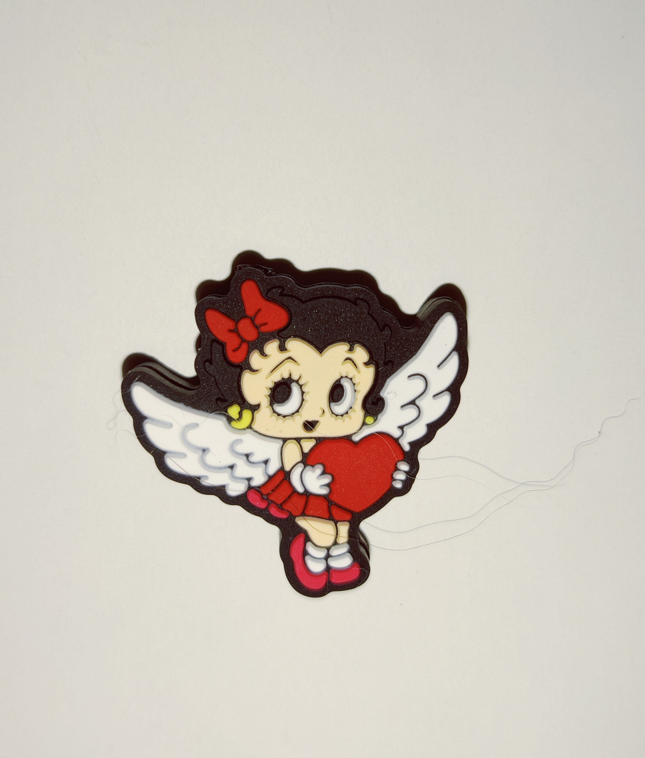 Looks similar to Betty boop with wings holding a heart silicone Focal bead