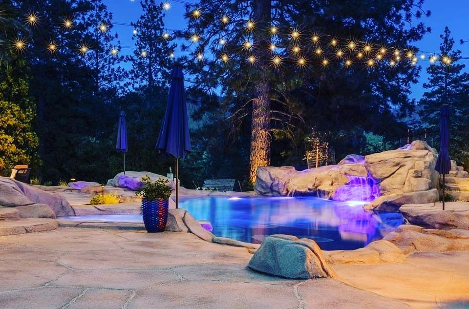 natural setting at night with lights on swimming pond
