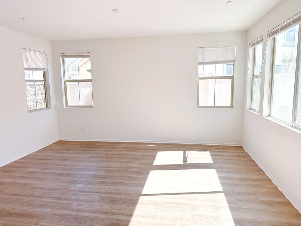 empty room after move out cleaning with clean floors and sunlight