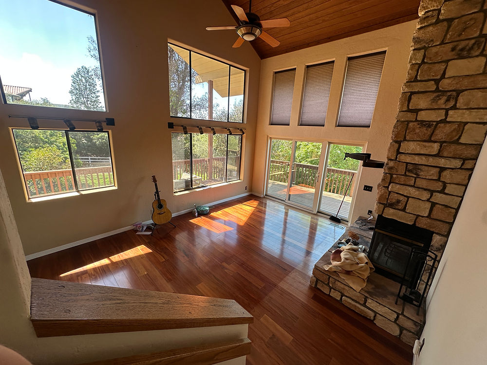 clean living room with large windows and polished floors