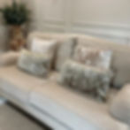 SJORS green /white rectangular cushion styled on a sofa in Lavish Lodge.