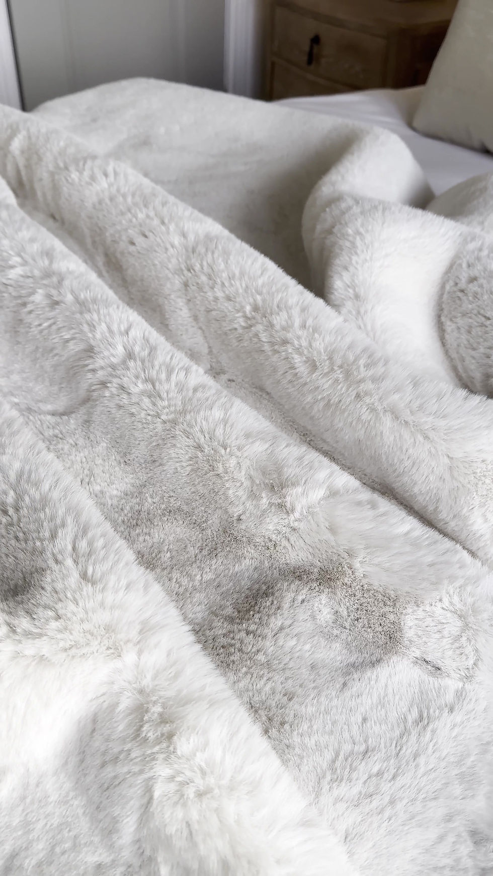 Thumbnail: Close up of the Rapture White Throw styled on a bed.
