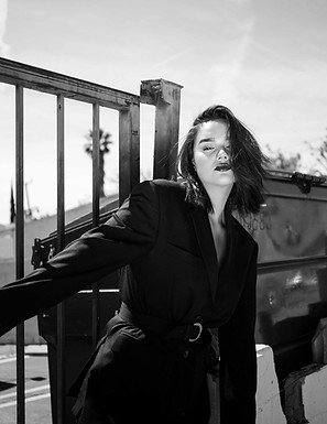 woman wearing black blazer holding grey 