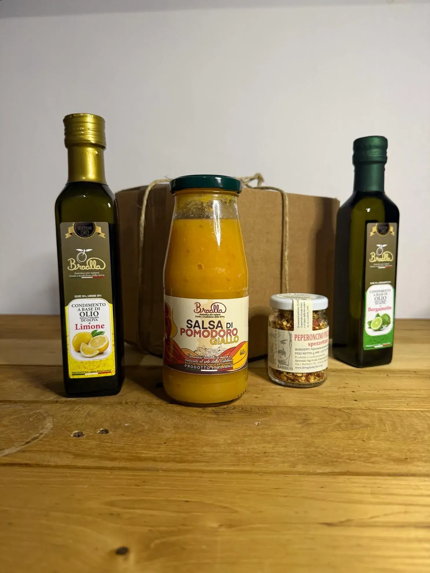 Olio extravergine al limone, olio al bergamotto calabrese, salsa di pomodoro giallo e peperoncino. Pacco da giù Sciroccu