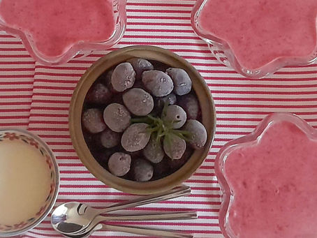Damson and apple tansy in glasses with a pot of damsons and cream and a ribbon stripe organic cotton tea towel in pink by Miller Honeyman.