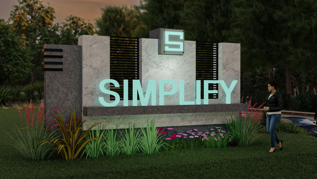  Nighttime illuminated monument sign with glowing teal “SIMPLIFY” letters on a stone base, accent lighting, and surrounding plants.