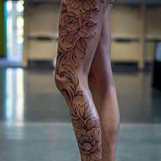 Elaborate floral leg tattoo