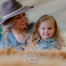 Smiling woman in a hat and young girl