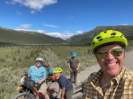 A family taking a selfie on the side of the road in Denali National Park.