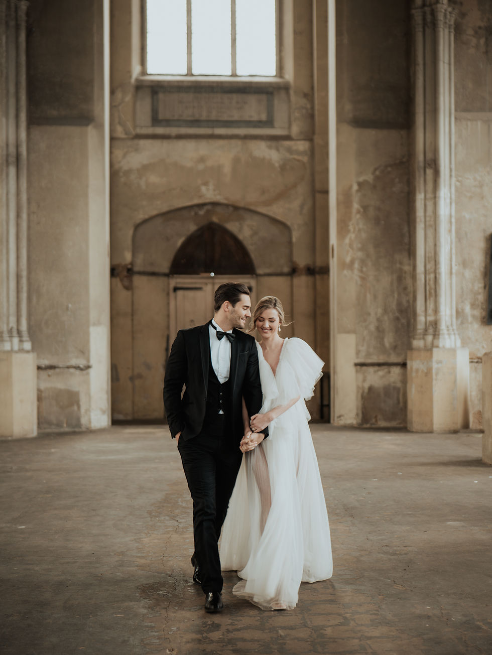 Layla Young and her fiancé Chris Jacobs. Layla wears a bespoke one of a kind gown by About Phaedra sourced by Amare Bride during an Benjamin Wheeler exclusive workshop which was held at The Heritage and Arts Centre, London, January 2023.  Photographed by Danielle Holden of Fineshade Studios.