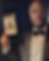 Man in a tuxedo holds a live drawing of himself labelled "Sean."