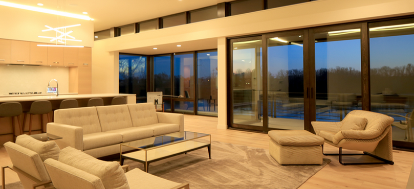 Modern one-level, open-plan home provides easy navigation from living room to kitchen and the rooms beyond, all with expansive river views through the east walls of glass as well as access to the back deck.