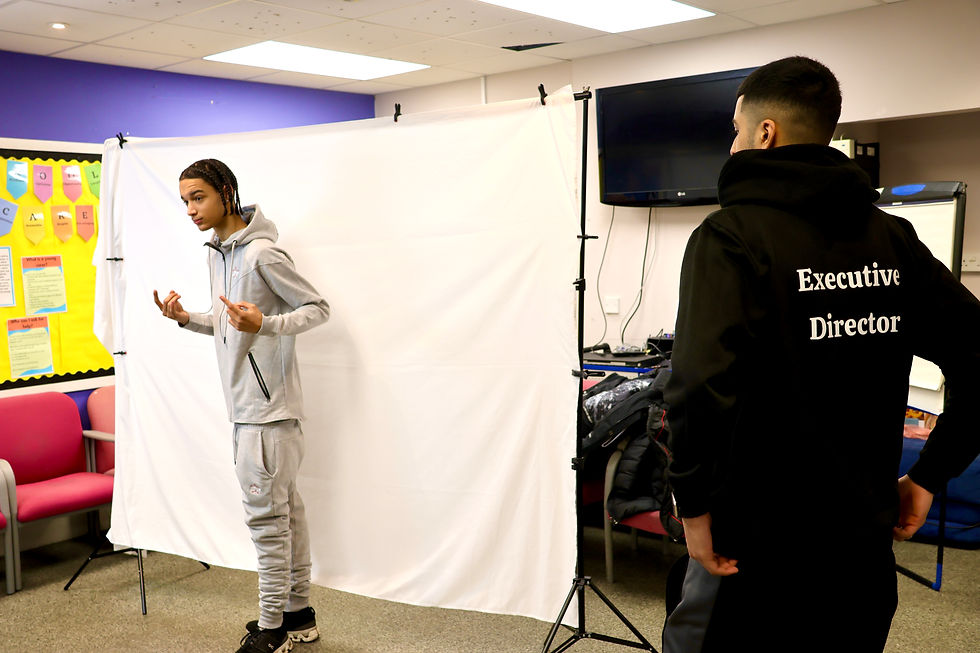 Young people practising modeling during a creative workshop.