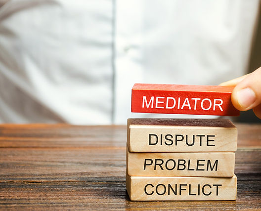 A man holds wooden blocks with the word Mediator, dispute, problem, conflict. Settlement o