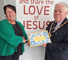 Witham Mayor Councillor Paul heath presenting a framed certificate to a lady from Witham United Reformed Church for participating in the Dementia Awareness Week window competition