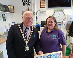 Witham Mayor Councillor Paul heath presenting a framed certificate to a lady from Witham Hub for participating in the Dementia Awareness Week window competition