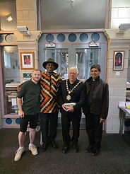 Cllr Paul Heath, Witham Mayor, wearing his chains and a suit, standing with 3 other gentlemen. On the left is the Deputy Mayor Cllr Jack Coleman in a shirt and shorts, a gentleman in a brown and beige top and a hat, and to the right of the Mayor a gentleman in a leather jacket