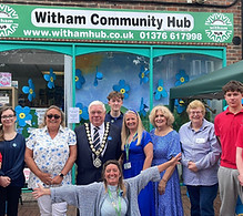 Witham Mayor Councillor Paul Heath and several members of the team from Witham Hub in front of their building during an event for Dementia Awareness Week