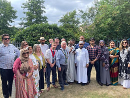 Witham Mayor and Deputy Mayor, Cllrs Paul Heath and Jack Coleman with a crowd of people, with the women mostly wearing saris. They are gathered outside on a grassy area with trees behind