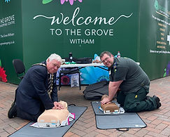 Witham Mayor Councillor Paul Heath and a member of St John Ambulance performing CPR compressions on two dummys
