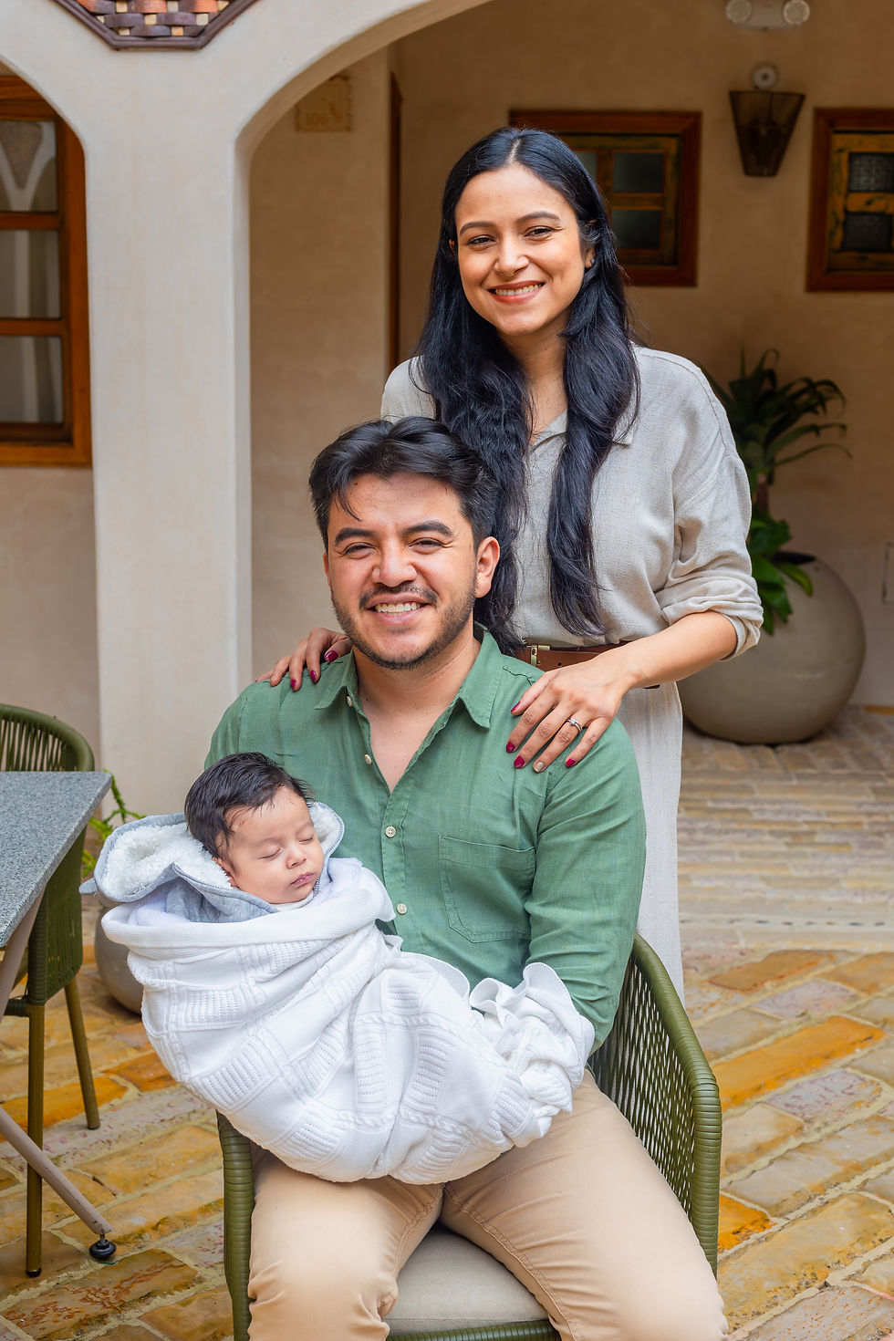 Padres sonrientes con su bebé en brazos