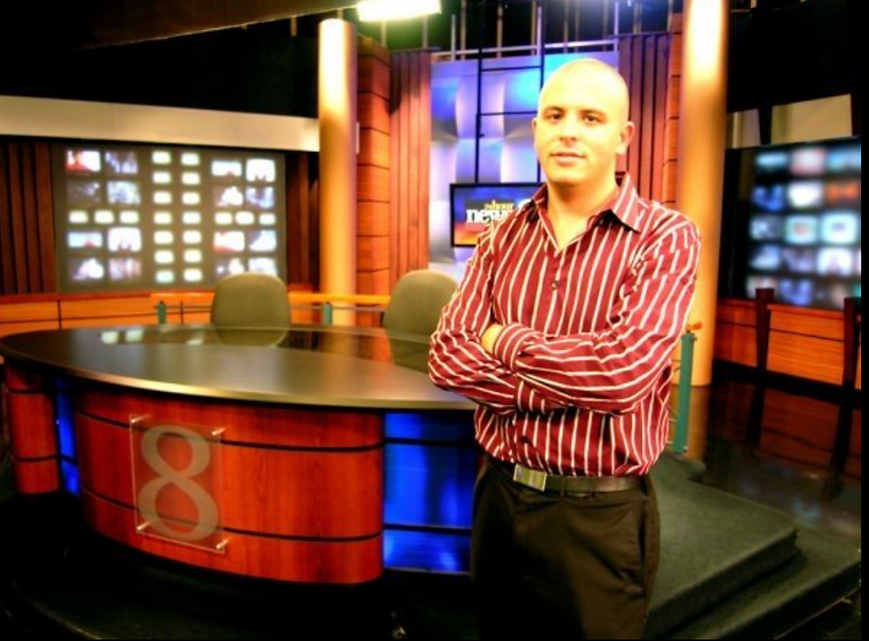 Andy in a news studio. 