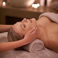 Face massage, spa and relax with woman, beauty and candles with hospitality and stress rel
