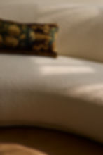 Cream boucle sofa with patterned pillow