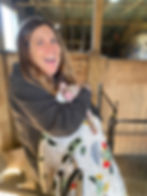 Sheriee Rusk holding a rescue piglet